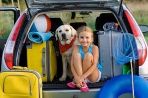 girl and pet dog in car